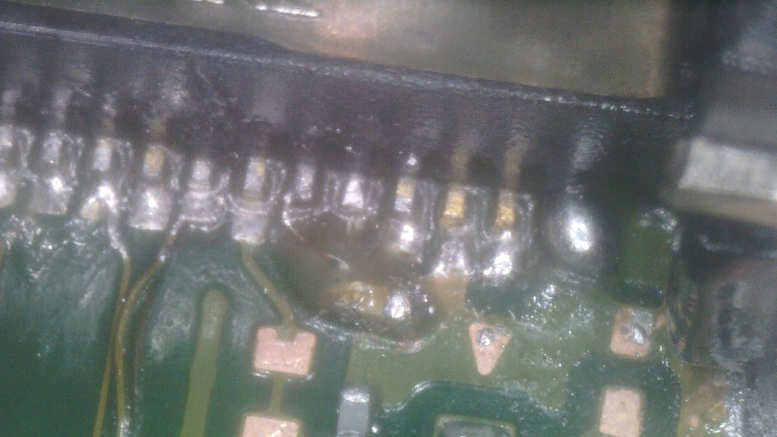 Ripped HDMI pads and jumper repairs under a microscope