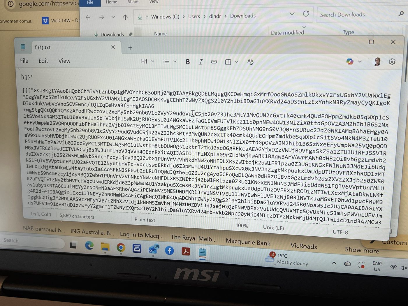 Suspicious downloaded file opened in Notepad showing encoded looking text