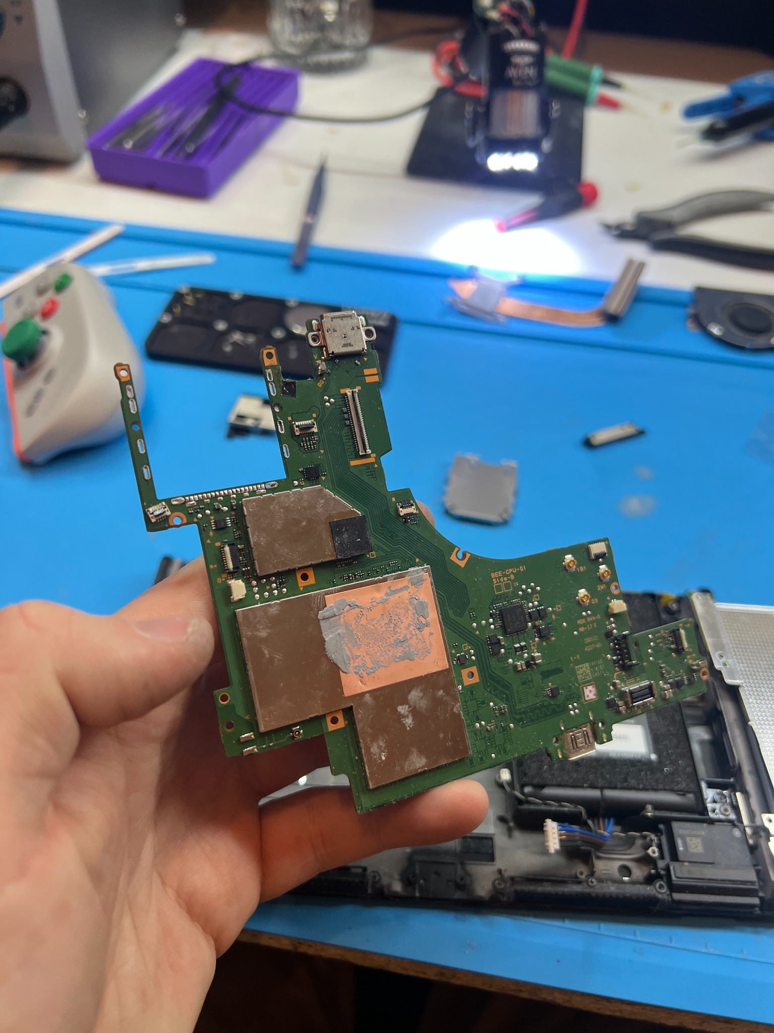 Switch 2 motherboard lifted out of the console with the game card reader removed