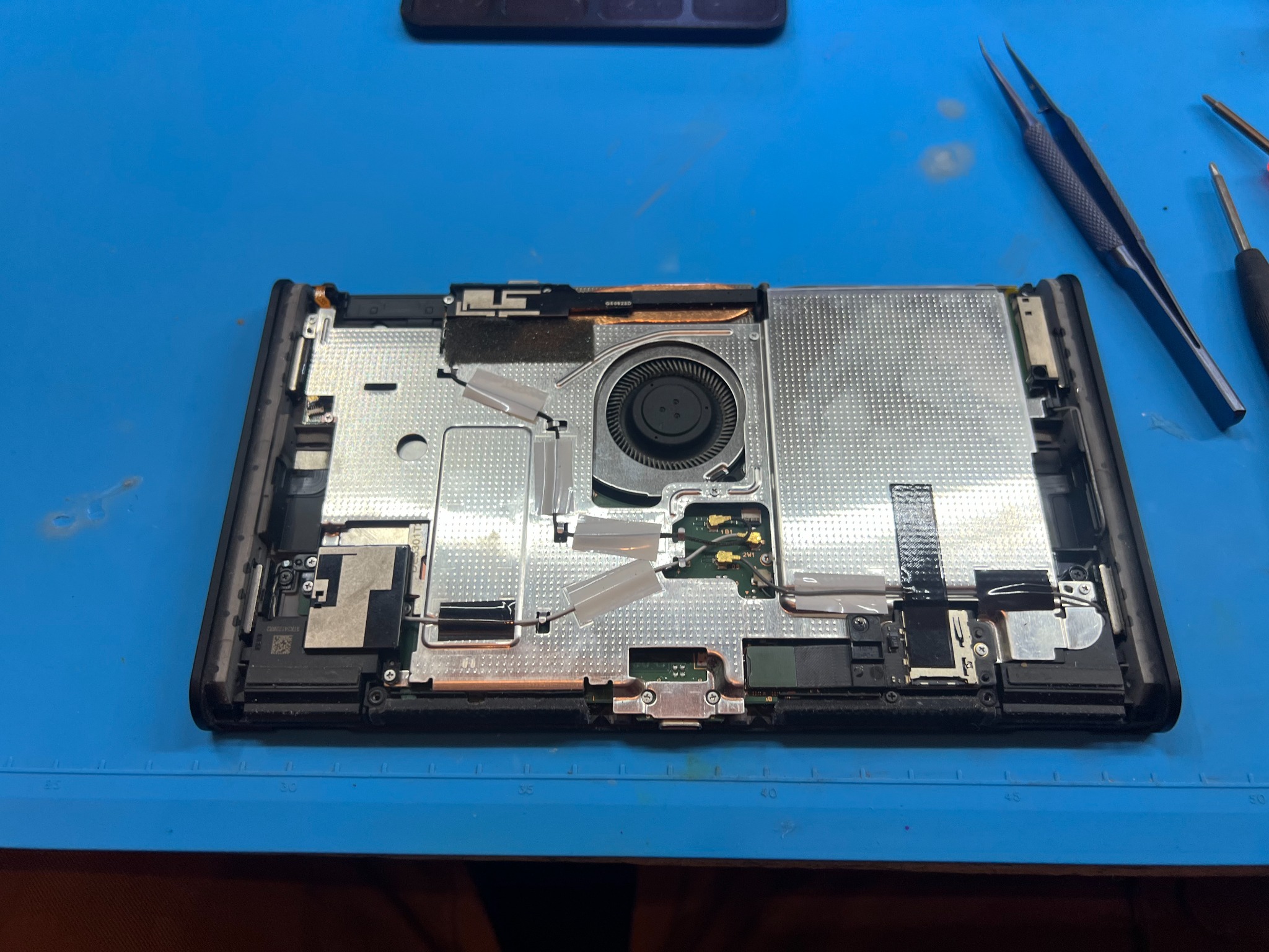 Nintendo Switch 2 with the rear cover removed and internal metal shielding exposed
