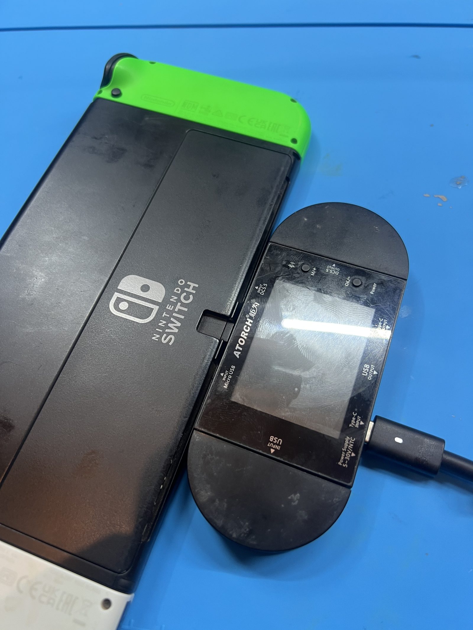 USB-C power meter connected the other way to a Nintendo Switch OLED during charging diagnosis