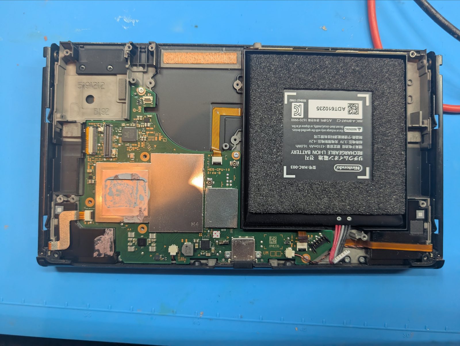 Nintendo Switch OLED opened for motherboard charging diagnosis